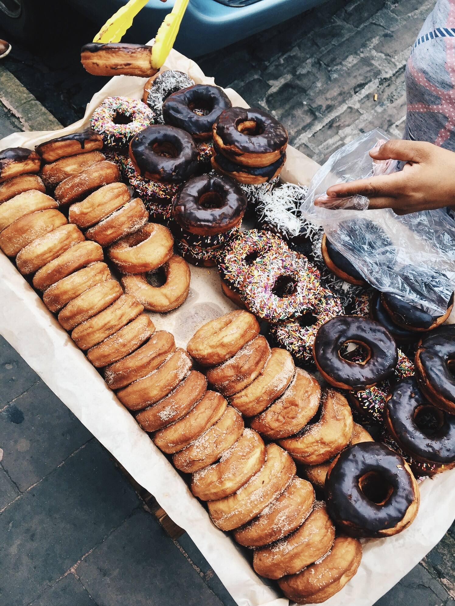 platter of mexican street donuts covered in sugar and chocolate.