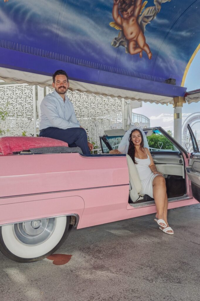 Newlyweds in Classic Pink Cadillac Wedding Car