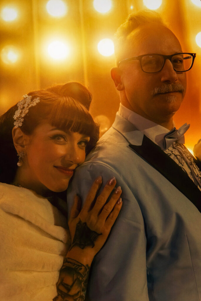Bride Resting on Groom’s Shoulder in Warm Glow