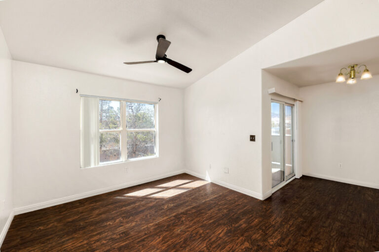A wide view of an empty condo’s interior featuring a spacious bright view of the property.